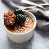 creme brulee with grand marnier garnished with fresh fig and blackberries