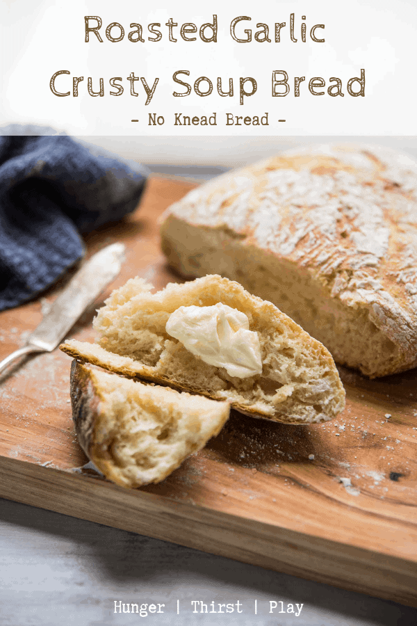 Tear into this easy no knead bread recipe in no time! A quick bread recipe that creates a crusty, crunchy outside and tender, chewy sweet garlic dough inside. This roasted garlic crusty soup bread is the perfect soup bread to dip and soak up broth or scoop ingredients! The roasted garlic flavor makes this crusty bread recipe perfect for serving alongside a main dish too. #noknead #breadrecipe #comfortfood