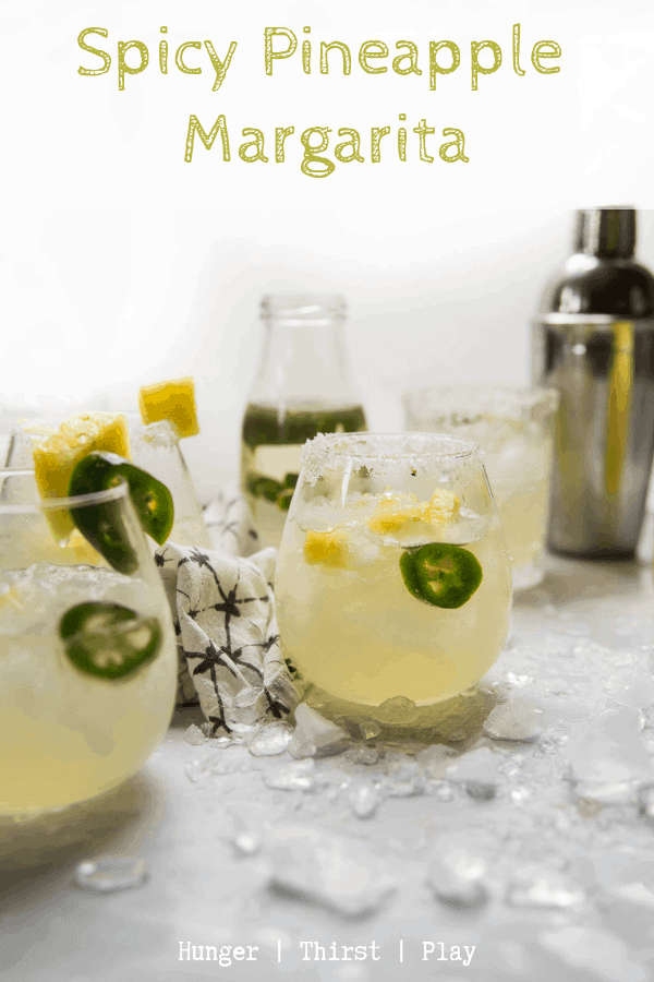 The best spicy pineapple margarita! Naturally infused pineapple tequila with super easy jalapeño simple syrup and a splash of lime makes for a well balanced, dangerously delicious spicy pineapple margarita. #margaritas #tacotuesday