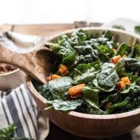 roasted butternut squash heats goat cheese and slightly wilts spinach leaves in a bowl