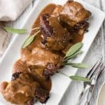platter of guinness braised short ribs with smooth sauce reduction