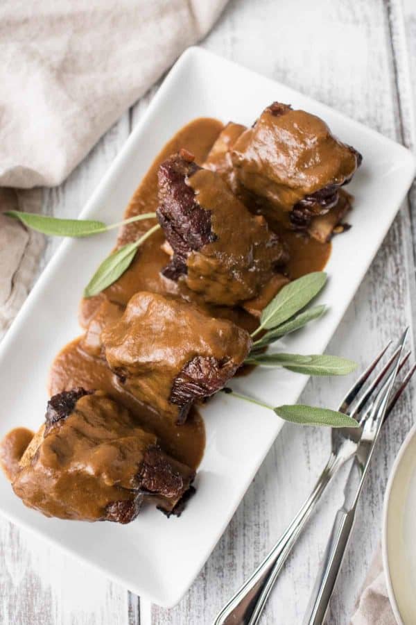 platter of guinness braised short ribs with smooth sauce reduction