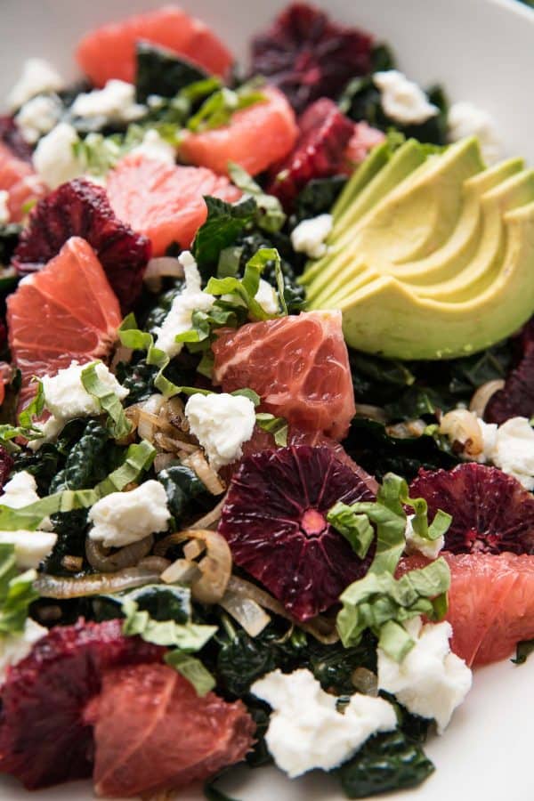 close up of blood oranges and grapefruits on kale citrus salad