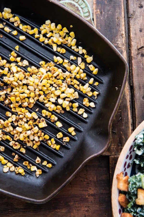 grilled corn kernels in a cast iron pan