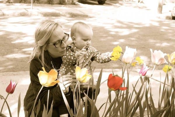 mama and little girl in the spring tulips