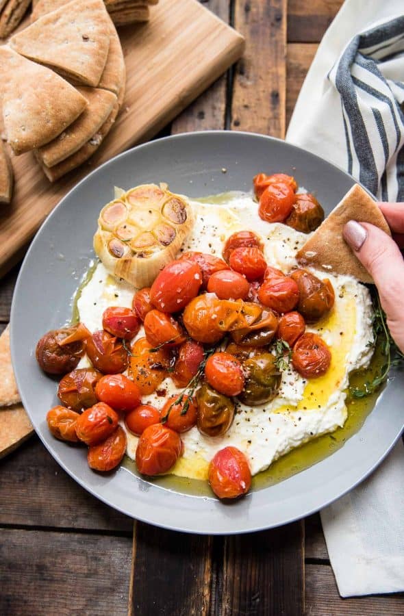 dipping soft pita bread into creamy whipped feta