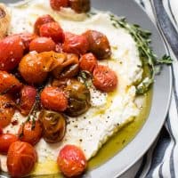 close up of whipped feta topped with roasted garlic olive oil