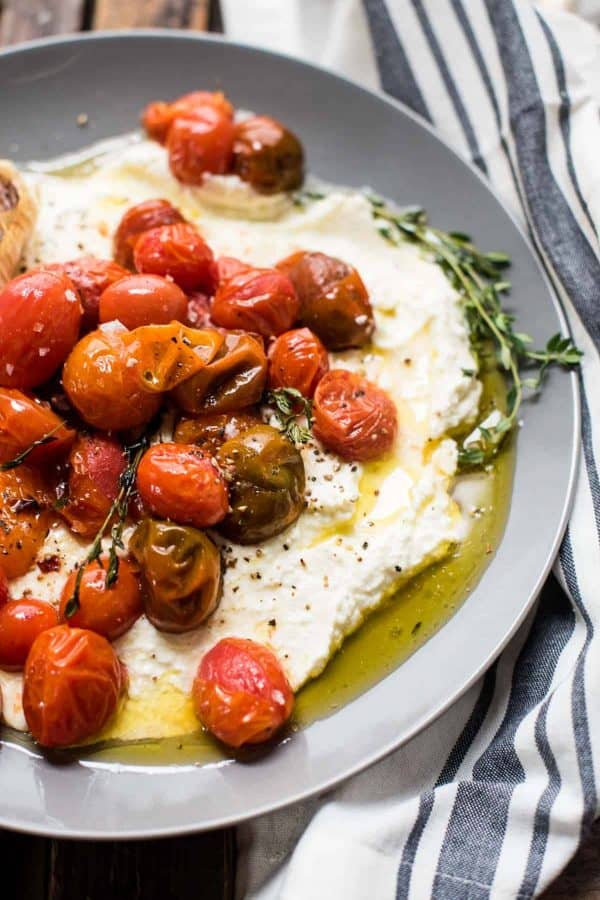 close up of whipped feta topped with roasted garlic olive oil