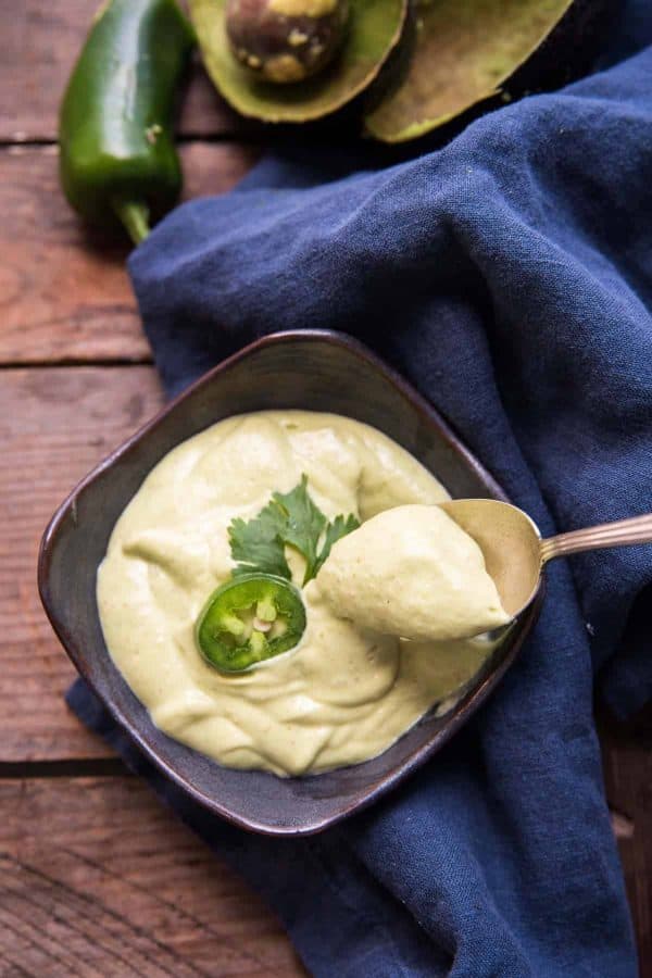 spoonful of thick and creamy avocado crema