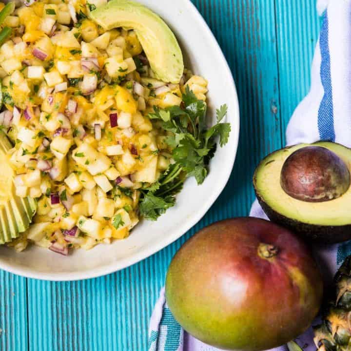 overhead view of pineapple mango salsa in a bowl with avocado