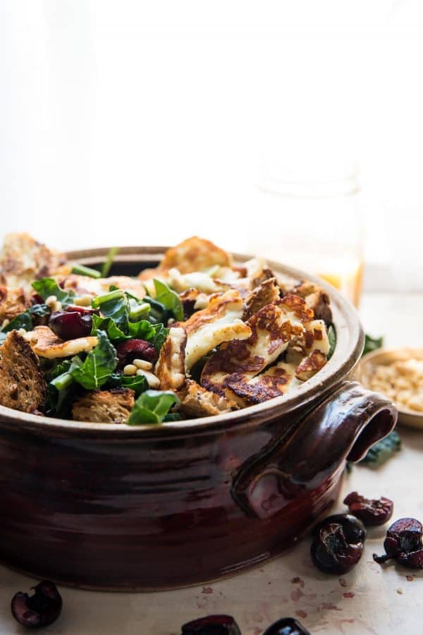 salad bowl stuffed with fried halloumi, kale and fresh cherries