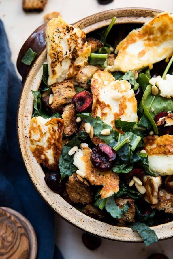 overhead view of fried halloumi over salad