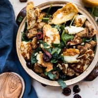 fried halloumi cheese and fresh cherries in a salad bowl