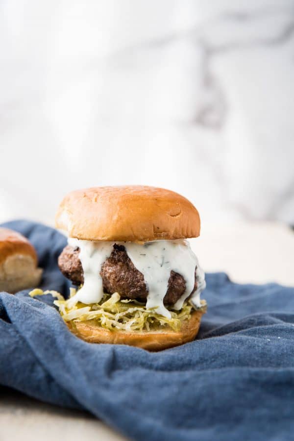 creamy tzatziki oozing over lamb patty