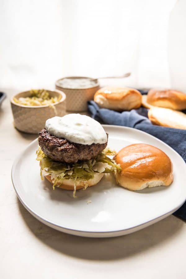 building the layers of feta stuffed lamb burgers