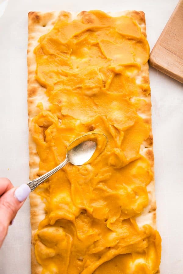 spreading squash puree on a prepared flatbread