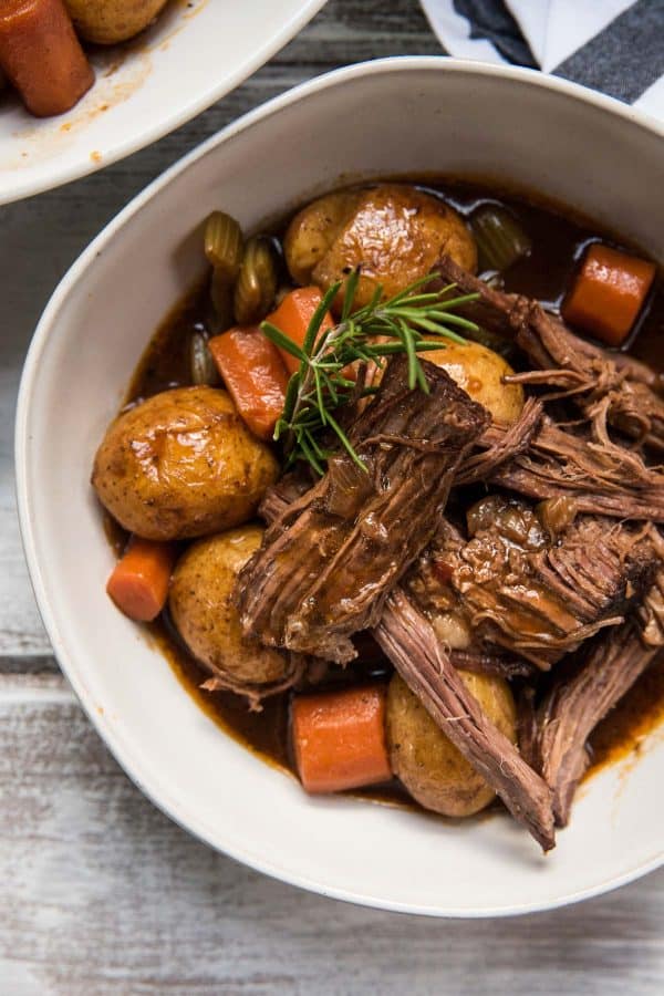 close up of serving of pot roast and veggies in a bowl