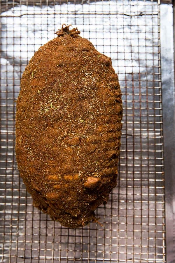 overhead view of lamb roast with spice rub before cooking