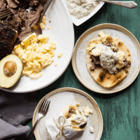 overhead view of a platter of ingredients and ready made breakfast lamb gyros