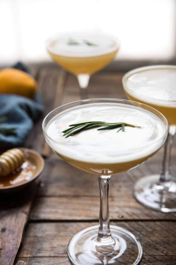 side angle of rosemary spring on top of a cocktail