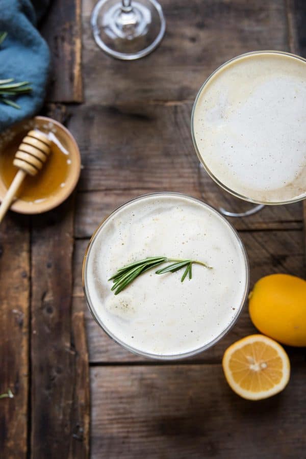 close up overhead view of rosemary garnish on a bees knees cocktail