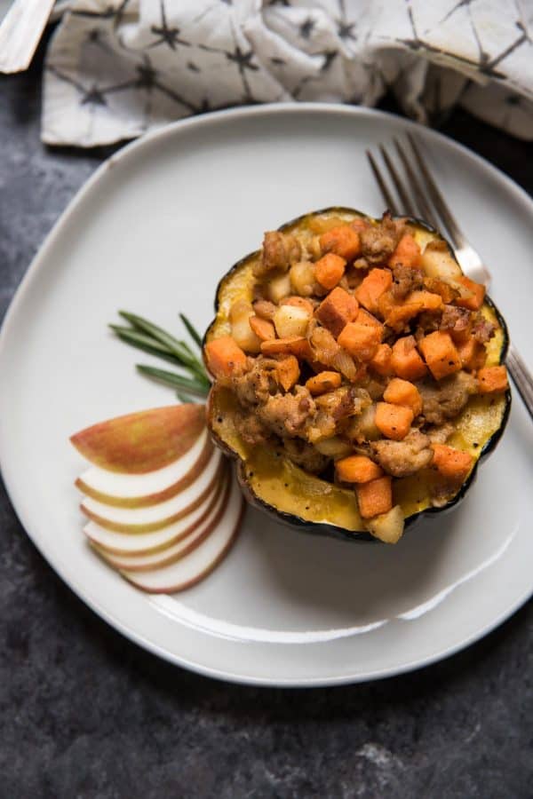 close up overhead view of acorn squash stuffed with fall ingredients