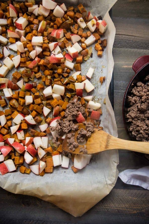 adding ground lamb and apples to sweet potato hash