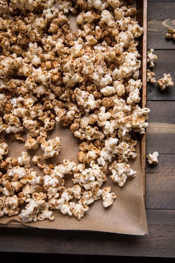 fresh popped gingerbread popcorn on a sheet pan