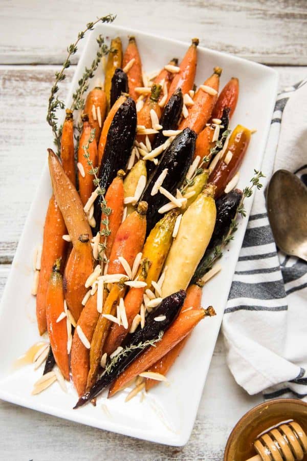 roasted carrots with honey, ginger and almonds on a plate
