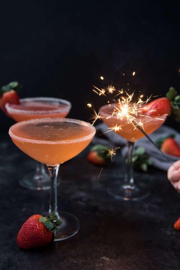 sparkler lighting up strawberry martinis