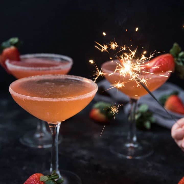 sparkler lighting up strawberry martinis