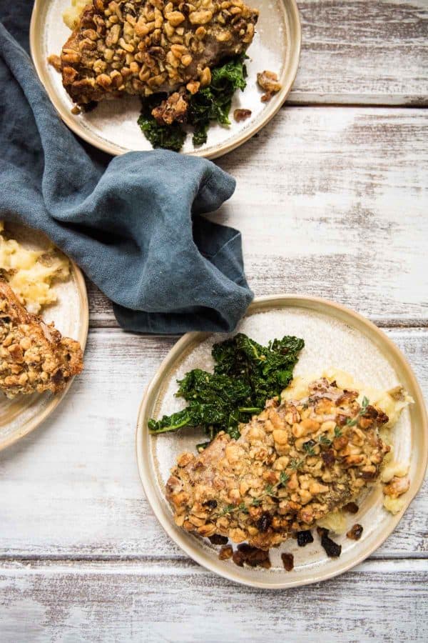 three plates with crispy pork chops, greens and mashed potatoes