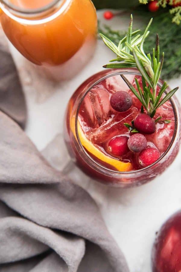 overhead angle of christmas sangria garnished with cranberries and rosemary