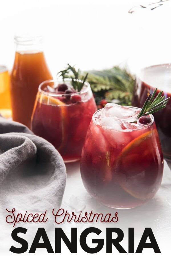 two glasses of red wine sangria with rosemary garnish