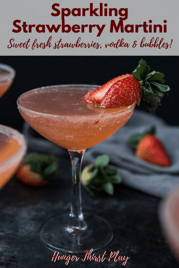 strawberry martini garnished with a fresh strawberry and sugar rim