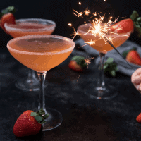 sparkler lighting up strawberry martinis
