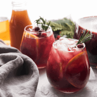 winter sangria poured into wine classes with sliced oranges and crushed ice