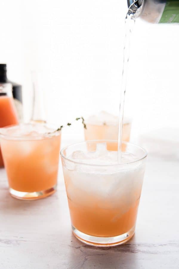 bubbly soda pouring into cocktail