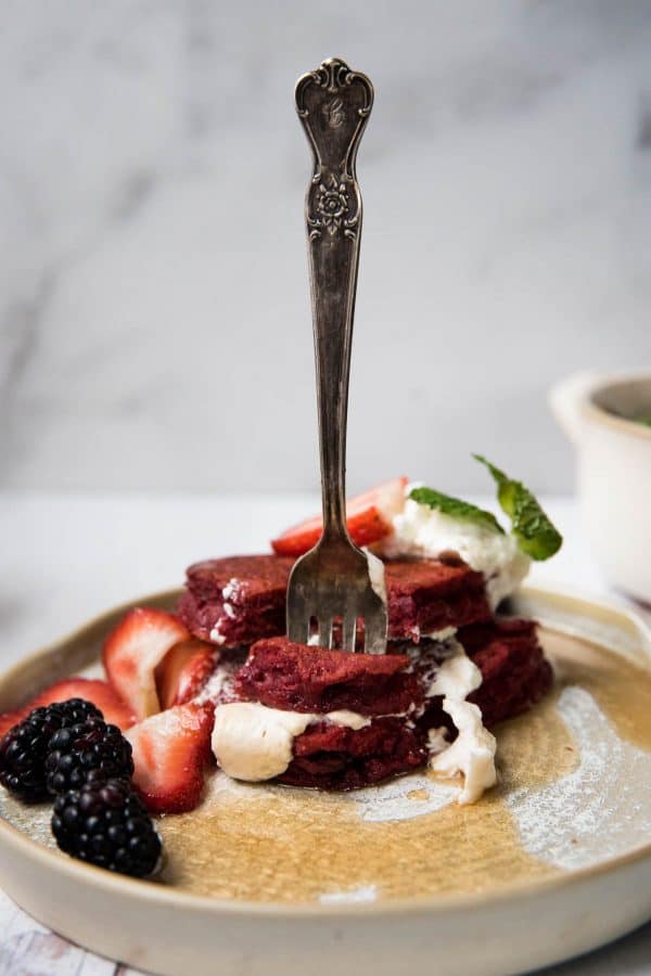 fork sticking out of red pancakes