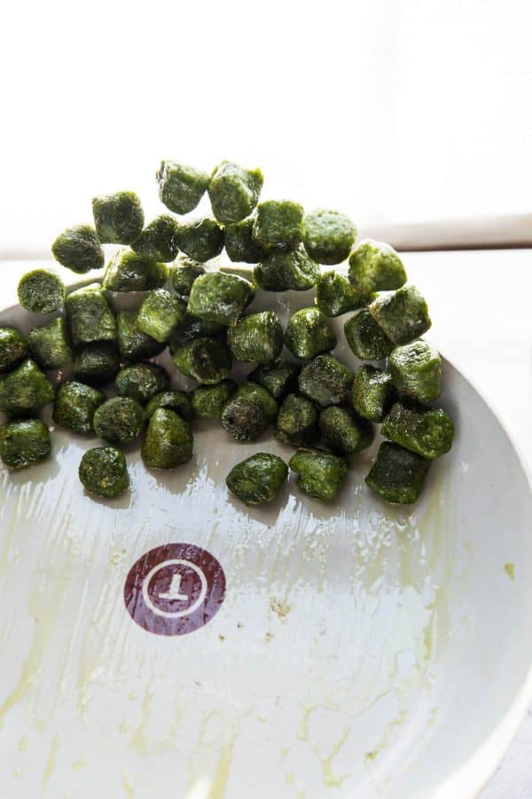 kale gnocchi being flipped in a saute pan