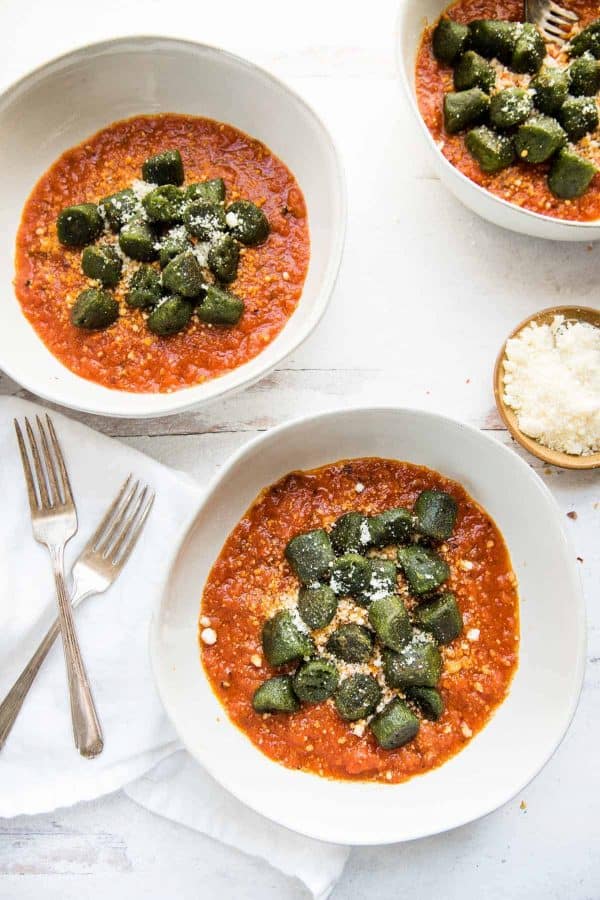 green kale gnocchi over spicy red tomato sauce