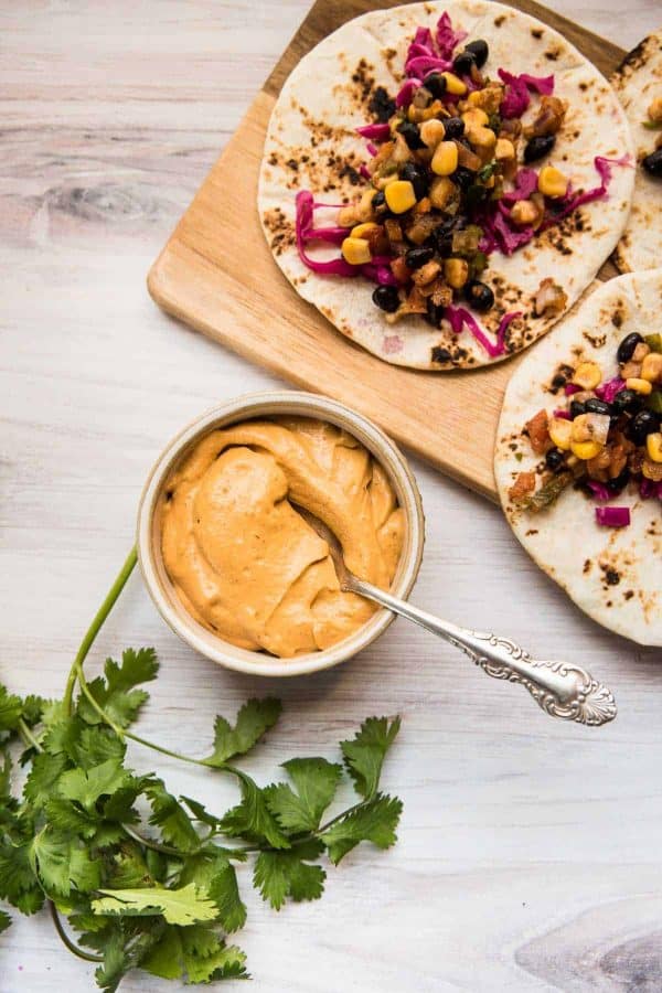 ramekin of vegan chipotle aioli and two tacos