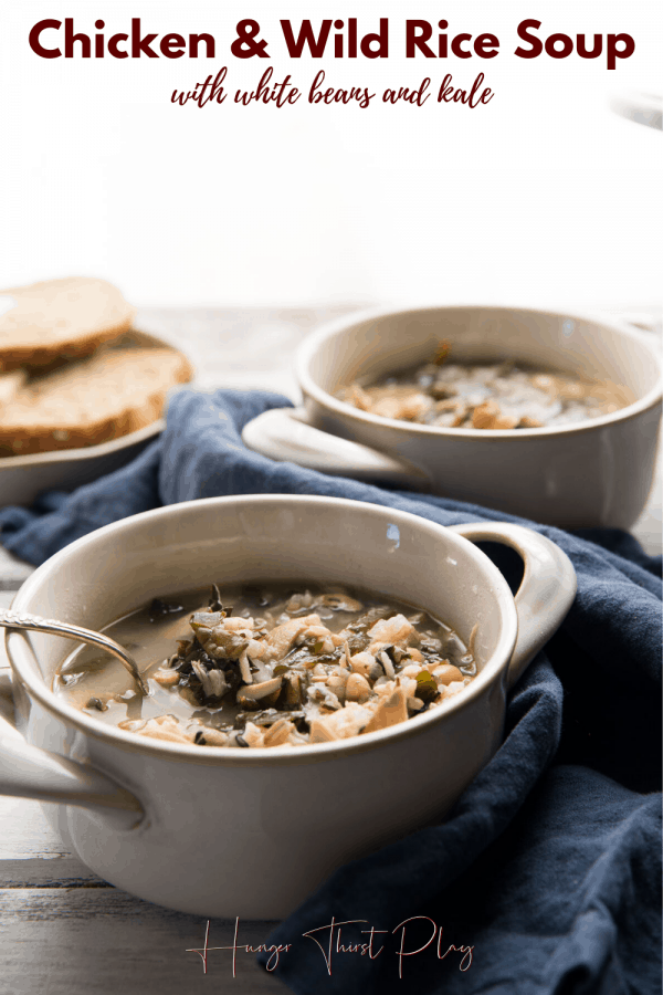 chicken and wild rice soup in bowls with spoon sticking out of them