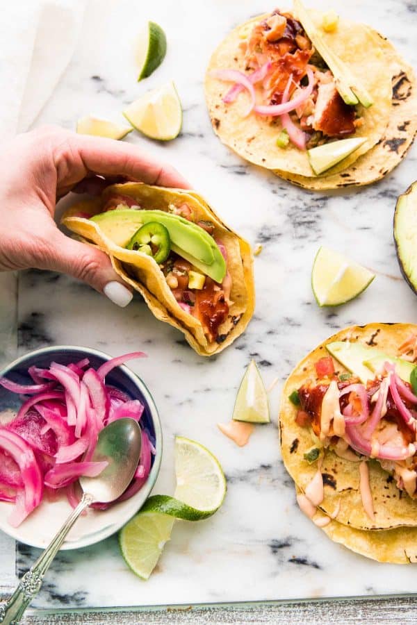 hand grabbing fish taco