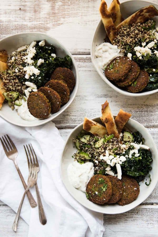 three bowls stuffed with falafel quinoa bowl ingredeints