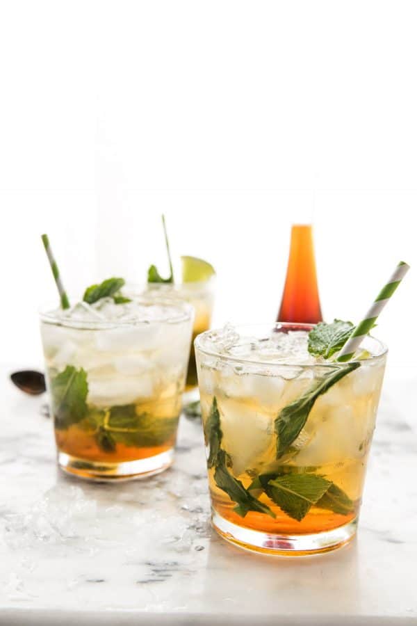 ice and mint filled cocktail glasses on marble