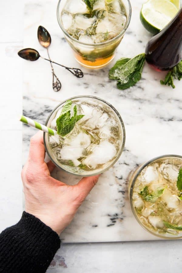 hand grabbing maple mint julep cocktail