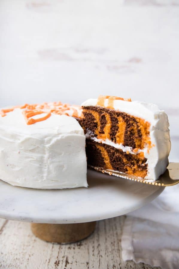 slice of tiger cake being cut out of the cake