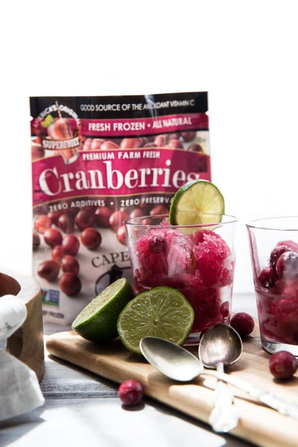 bag of frozen cranberries and glasses filled with frozen cape codder slushies