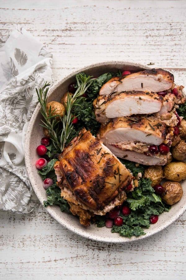 stuffed pork roast over greens on a platter